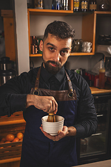 Image showing Barman mixing matcha green tea