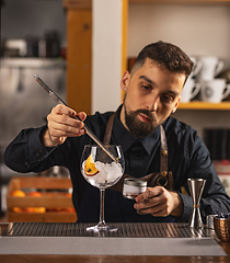 Image showing Expert barman is making cocktail