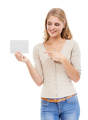 Image showing Woman, pointing at card and advertising, presentation or announcement with information on poster on white background. About us, coming soon or sign up with news, marketing or ads with board in studio