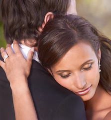 Image showing Couple, unity and embrace on wedding day for love, support and together for marriage and commitment. People, romance and hugging at outdoor ceremony, loyalty and ring for devotion and partnership