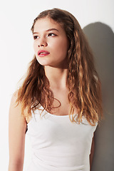 Image showing Serious, beauty and young woman in studio with makeup, cosmetic and glamour face. Confident, natural and beautiful female model from Australia with hairstyle for fashion isolated by white background.