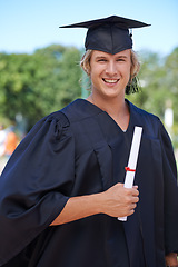 Image showing Graduation, portrait and student on campus with certificate, smile and success with university education. School, scholarship and happy man with diploma for academic achievement with college degree.