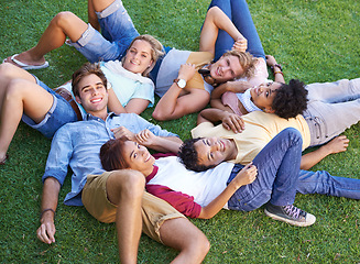 Image showing Friends, group and grass or lying in circle in park or university relax, student peers or happy. Man, woman and portrait in nature or diversity on college campus or summer rest, weekend or connection