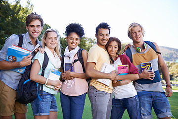 Image showing Books, portrait or students in park at college, campus or together with community, smile or group. University, diversity or happy people bond with support, hug or solidarity in education in garden