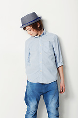 Image showing Child, boy and confidence for fashion in studio, cool clothing and attitude by white background. Male person, kid and cool hat by backdrop or pride for style, face and trendy outfit in childhood