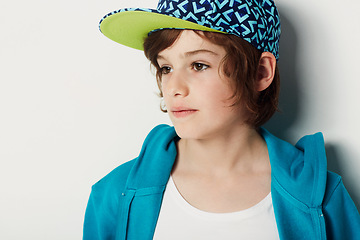 Image showing Thinking, fashion and young child in a hoodie in studio isolated on a white background. Trendy style, cool kid and cap of boy or model in a hat, casual clothes and serious on a backdrop in Sweden