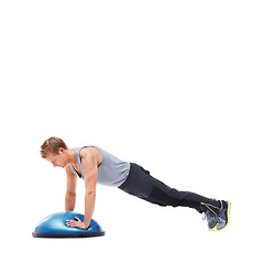 Image showing Man, half ball and push up or training in studio, core strength and workout challenge for wellness. Male person, athlete and equipment for exercise, mockup space and performance by white background