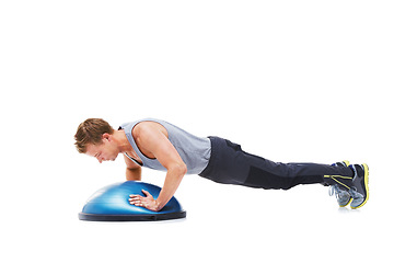 Image showing Man, half ball and push up or fitness in studio, core strength and workout challenge for wellness. Male person, athlete and equipment for training, mockup space and performance by white background