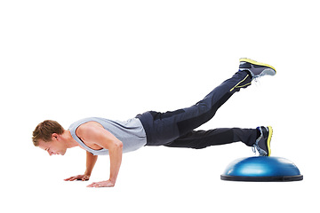 Image showing Man, half ball and push up in studio for fitness, core strength and workout challenge for wellness. Male person, athlete and equipment for training, mockup space and performance by white background
