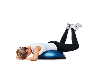 Image showing Woman, balance ball and lying workout, balance or exercise on a white studio background. Young person or athlete on half round object in training, health and wellness or fitness on mockup space