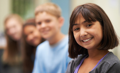 Image showing Girl, portrait and happy in corridor at school with confidence and pride for learning, education or knowledge. Student, person or face with smile in building or hallway before class or ready to study