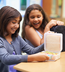 Image showing Happy girl, friends and student with lunchbox for eating meal, break or snack time in classroom at school. Young kids or elementary children smile for container, food or fiber and nutrition in recess