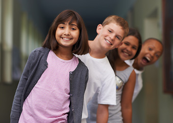 Image showing Girl, portrait and friends in line at school with confidence and pride for learning, education or knowledge. Student, people and face with smile in building or hallway before class or ready to study