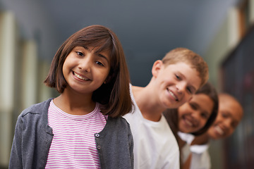 Image showing Girl, portrait and friends in row at school with confidence and pride for learning, education or knowledge. Student, people and face with smile in building or hallway before class or ready to study