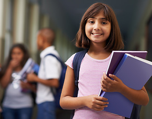 Image showing Girl, portrait and happy in corridor of school with backpack or books for learning, education or knowledge. Student, person and face with smile in building or hallway before class or ready to study