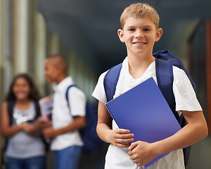 Image showing Boy, portrait and happy in corridor of school with backpack and books for learning, education or knowledge. Student, person and face with smile in building or hallway before class or ready to study