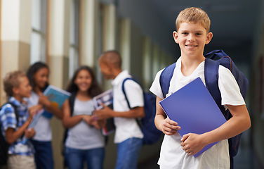 Image showing Boy, portrait and smile in corridor of school with backpack and books for learning, education or knowledge. Student, person and face with happy in building or hallway before class or ready to study