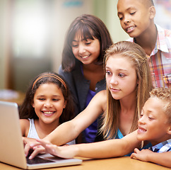 Image showing Young tutor, laptop and teaching children. kids or pupils technology, social media or research in class. Group of elementary students with mentor showing tech, internet or online search in classroom