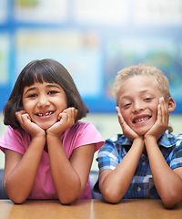 Image showing Students, children and portrait or happy in classroom for learning, knowledge or education at desk. Kids, face and smile at academy or school with confidence or pride for development and diversity