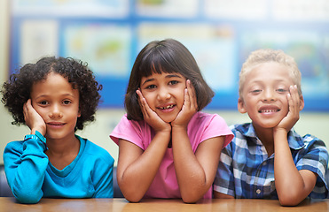 Image showing Students, friends and portrait or happiness in classroom for learning, knowledge or education at desk. Kids, face and smile at academy or school with confidence or pride for development and diversity