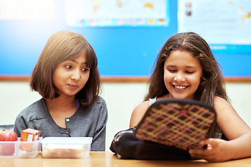 Image showing Happy children, students and eating lunch in classroom at school for meal, break or snack time. Young little girls or elementary kids smile with brain food for health, nutrition or vitamins in class