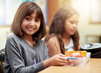 Image showing Girl, smile and portrait with lunch at school for recess, break or nutrition at table with meal. Kid, face and happy at academy or relax with confidence, food and pride for childhood development