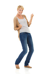 Image showing Happy woman, portrait and fist pump in celebration for winning on a white studio background. Young female person, model or blonde smile for achievement, good news or promotion deal on mockup space