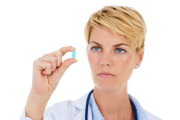 Image showing Woman, doctor and pill for prescription or medicine, inspection and drug dispensary in studio. Female pharmacist, medical research and healthcare or inventory, supplement and care by white background