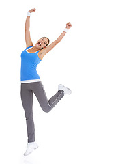 Image showing Woman, fitness celebration and yes in studio for exercise, workout achievement and body goals or dance. Sports model with fist, energy or surprise portrait for training results on a white background