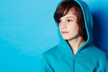 Image showing Studio, fashion and young child in hoodie, trendy apparel or stylish outfit isolated on blue background. Mockup space, fashionable style and youth kid with winter clothes, casual outfit and thinking