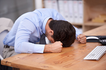 Image showing Business man, stress and resting on desk, burnout and mental health or overworked in workplace. Male professional, frustration and banging table in anger, bankrupt and overwhelming debt or pressure