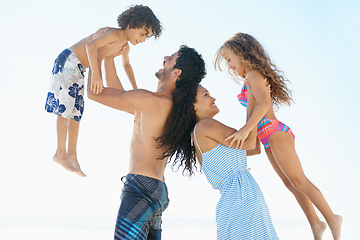 Image showing Happy family, beach and lifting children in bonding, vacation or outdoor holiday weekend together. Father, mother and child smile for love, support or summer by ocean coast with blue sky background