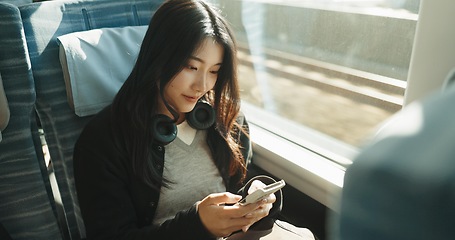 Image showing Japan woman, travel and train on smartphone, social media and public transportation on metro bullet. Person, cellphone and online on fast vehicle for weekend trip and commute in tokyo for adventure