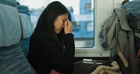 Image showing Train, tired and woman in city for travel, commute and journey on metro transportation in town. Passenger, railway and person with headache, frustrated and exhausted on trip in public transport