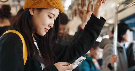 Image showing Japanese woman, online and train on smartphone, social media and public transportation on metro bullet. Person, cellphone and travel on fast vehicle for weekend trip and commute in tokyo on adventure