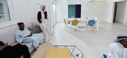 Image showing A Muslim family gathers, eagerly awaiting Iftar, fostering a sense of unity, cultural richness, and familial connection during the holy month of Ramadan