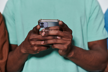 Image showing African American teenager engages with his smartphone against a pristine white background, encapsulating the essence of contemporary digital connectivity and youth culture