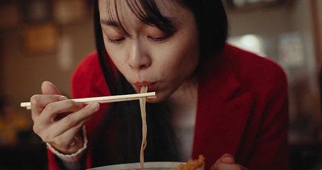 Image showing Woman, ramen and eating noodles in restaurant for nutrition, healthy meal and diet. Hungry lady, chopsticks and spaghetti for lunch, dinner and Japanese cuisine in cafeteria, diner and fast food menu