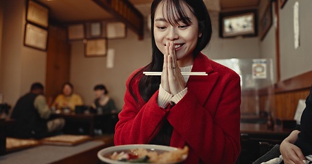 Image showing Restaurant, praying and Japanese woman with food for lunch, dinner and supper in cafeteria. Happy, smile and person with prayer hand gesture and chopsticks for eating meal, wellness and nutrition