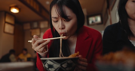 Image showing Woman, restaurant and eating ramen noodles for nutrition, gourmet dining or meal with friends. Hungry lady, chopsticks or spaghetti for lunch, dinner or Japanese cuisine, fast food diner or cafeteria