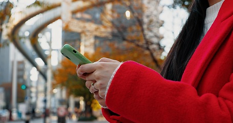 Image showing City, hands and woman with phone for typing on social media, download digital app and scroll notification. Closeup, smartphone and mobile contact in urban street to search for travel location online