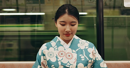 Image showing Japanese woman, happy and travel by train in kimono and public transport on metro bullet in city. Person, journey or traditional clothes in fast vehicle on weekend or commute in tokyo on adventure