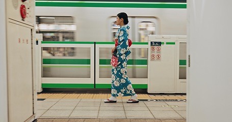 Image showing Woman, waiting and travel by train in kimono and public transportation on metro bullet in city. Person, journey and traditional clothes in fast vehicle on weekend and commute in tokyo for adventure