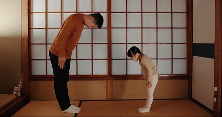 Image showing Traditional, home and Japanese father and child bow for greeting ceremony, ritual and respect. Family, culture and dad with young girl in indigenous house for bonding, relationship and love together