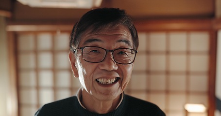 Image showing Happy, portrait and senior Japanese man at his home with positive, good and confident attitude. Smile, glasses and face of elderly male person in retirement with pride in modern house in Tokyo Japan.