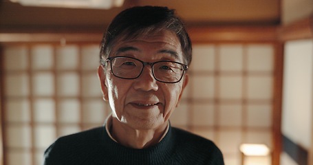 Image showing Smile, portrait and senior Japanese man at his home with positive, good and confident attitude. Happy, glasses and face of elderly male person in retirement with pride in modern house in Tokyo Japan.