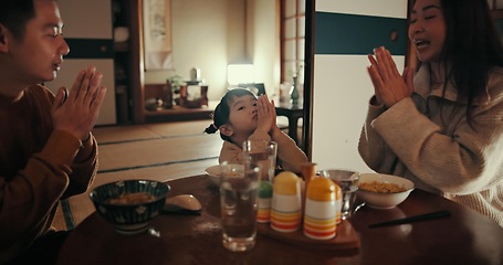 Image showing Family, food and dinner in home with praying for gratitude, mindfulness and thankful at dining room table. Japanese, parents and girl child with prayer in lounge for lunch, brunch or breakfast