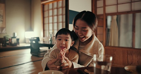 Image showing Food, home and Japanese mother and child at table for lunch, breakfast and eating meal together. Happy family, culture and mom and young girl in traditional house for bonding, relationship and love