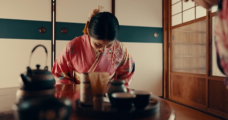 Image showing Woman in Japanese tea house with bow, kimono and relax with mindfulness, respect and gratitude. Girl at calm tearoom for matcha drink, zen culture and ritual at table for traditional ceremony in home