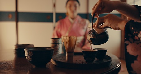 Image showing Woman pouring traditional Japanese tea with kimono, teapot and relax with mindfulness, respect and service. Girl at calm tearoom with matcha drink in cup, zen culture and ritual at table for ceremony